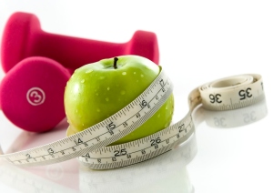 Picture of weights, measuring tape and healthy apple
